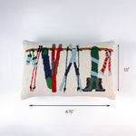Rectangular pillow with colorful ski gear hanging from a rack shown with a 4.75 inch length and 1.5 inch height indicator.