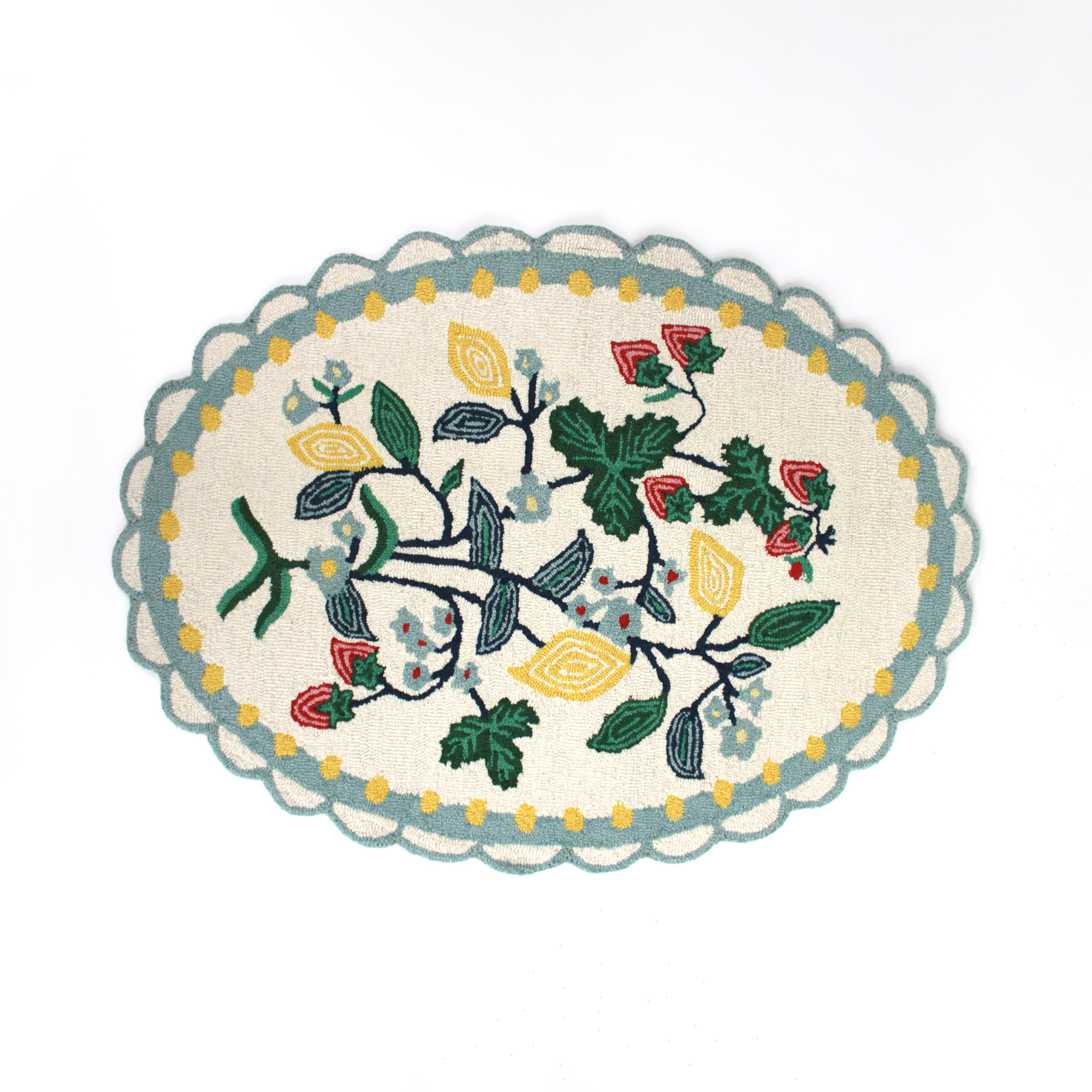 An small oval scalloped rug with strawberry and floral motifs