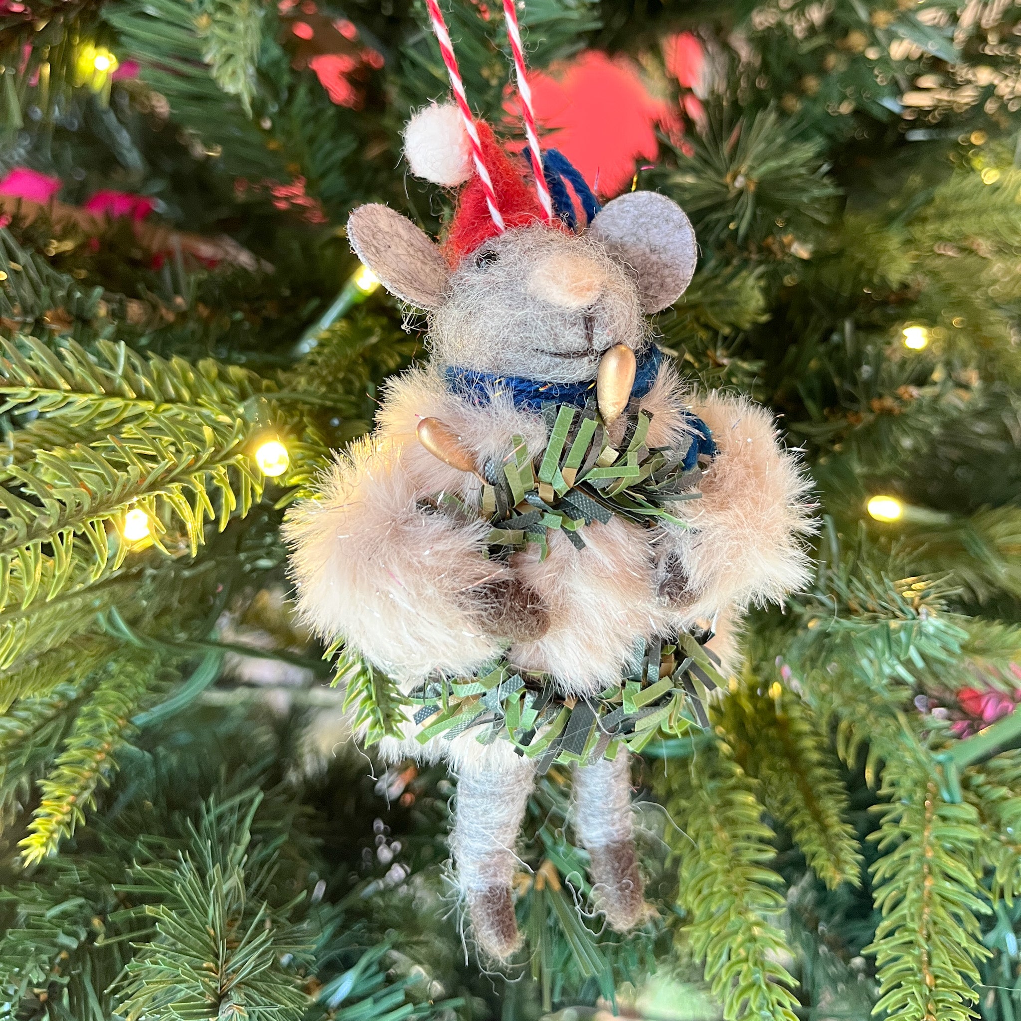 one festive felt mouse ornament dressed in fuzzy holiday outfits and Santa hats holding Christmas wreath