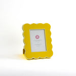 Yellow 5 x 7 scalloped photo frame on a white background