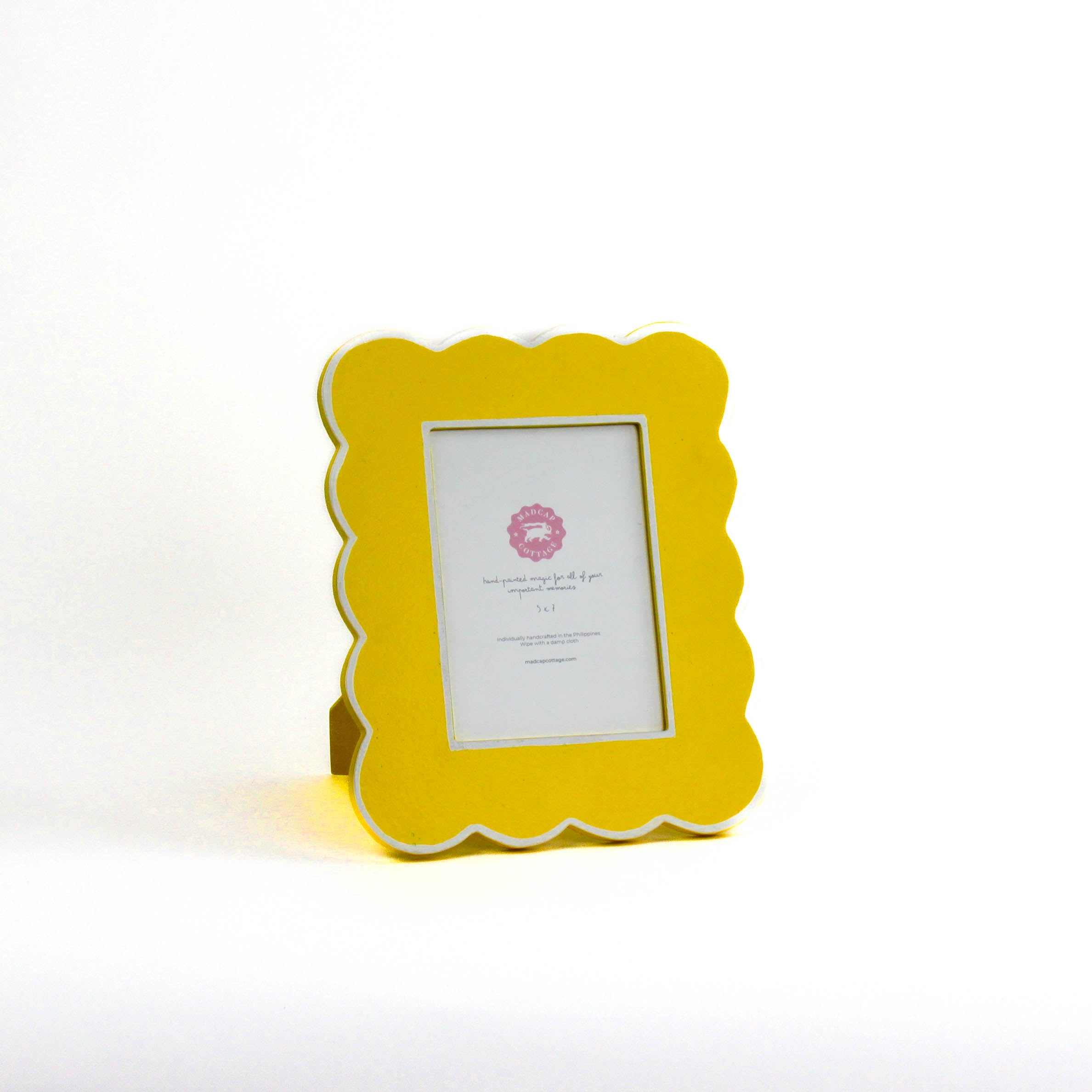 Yellow 5 x 7 scalloped photo frame on a white background