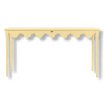 A custom yellow console table with scalloped edges