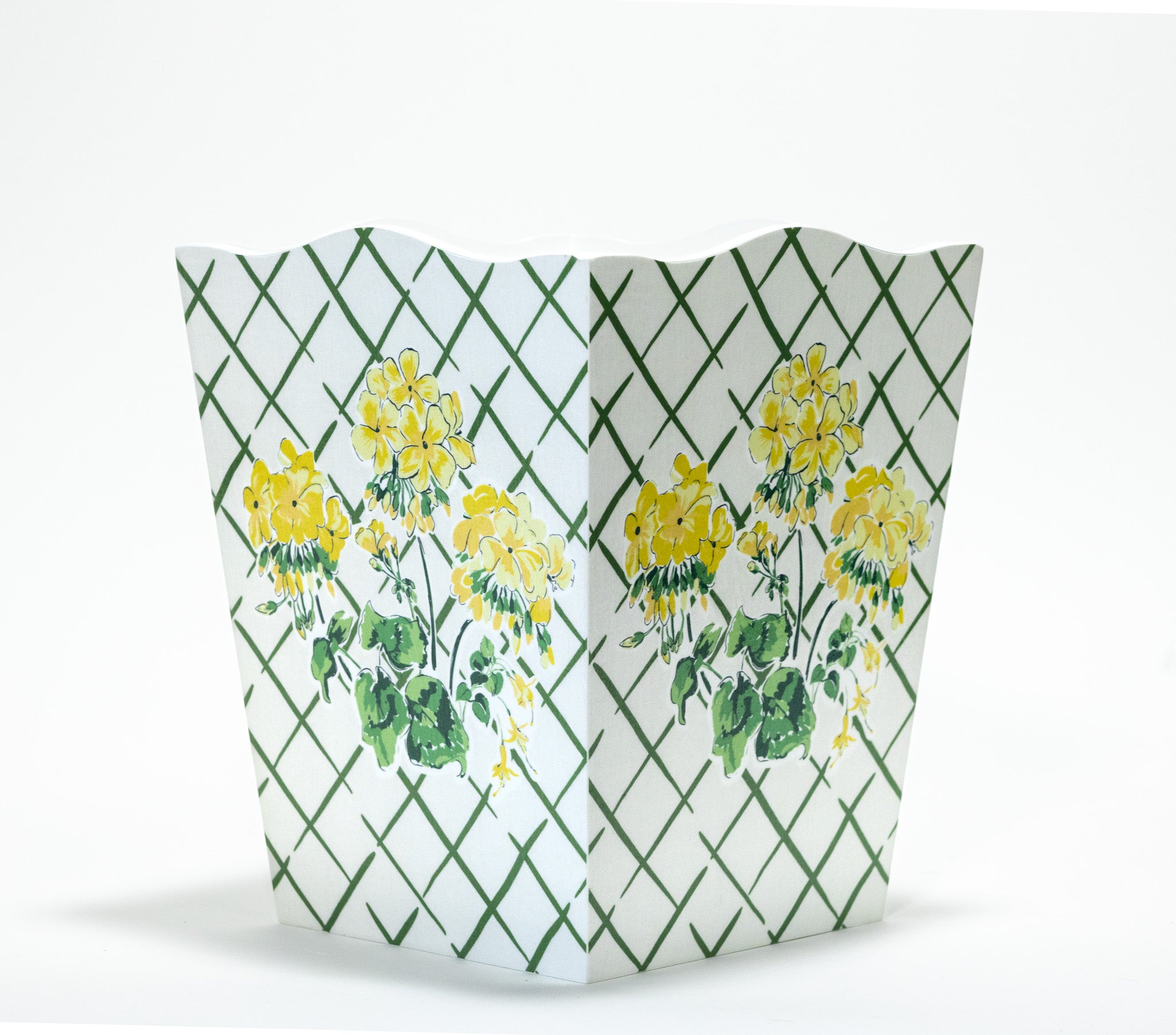 a white and green floral wastepaper basket by madcap cottage with a central yellow geranium motif. 