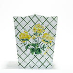 a white and green floral wastepaper basket by madcap cottage with a central yellow geranium motif. 