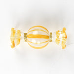 yellow glass candy christmas ornament on a white background