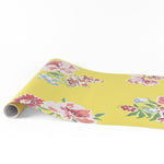 yellow pink green floral paper table runner with colorful blooming flower pattern.