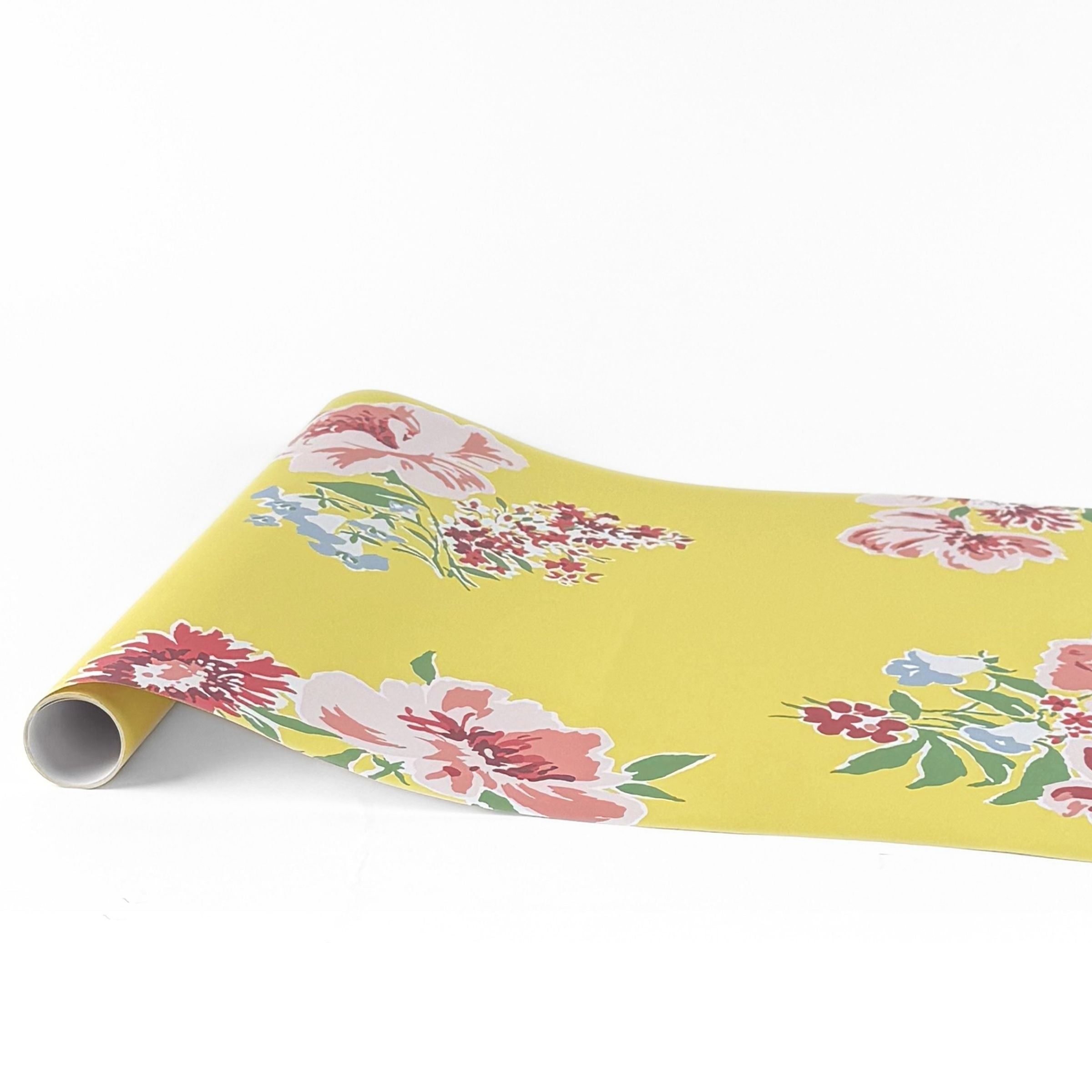yellow pink green floral paper table runner with colorful blooming flower pattern.