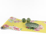 Yellow pink green floral paper table runner styled with decorative cabbage bowls.