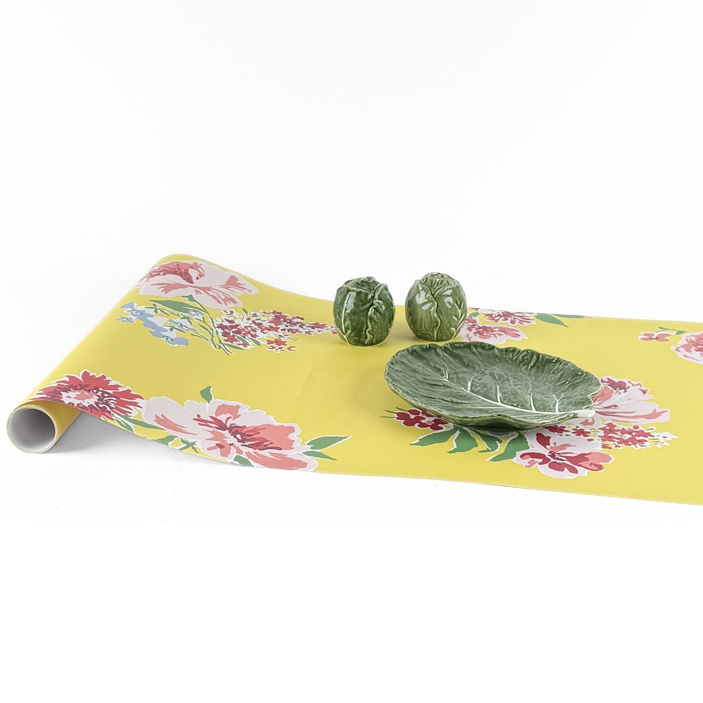 Yellow pink green floral paper table runner styled with decorative cabbage bowls.