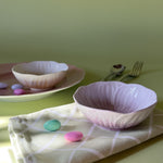 yellow and purple flower shaped bowls on a table