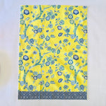 a yellow chinoiserie tea towel with blue cherry blossom motifs.