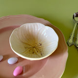 yellow flower shaped bowls resting on a pink plate
