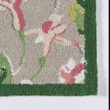 Close up of a pink and green rug with a green border