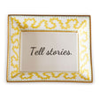 Madcap Cottage yellow and white porcelain trinket tray with a gold border and a saying that says Tell Stories.