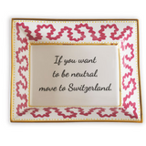 Madcap cottage pink and white porcelain trinket tray with a gold border and a saying that says If you want to be neutral move to Switzerland.