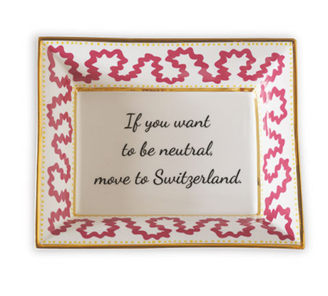 Madcap cottage pink and white porcelain trinket tray with a gold border and a saying that says If you want to be neutral move to Switzerland.