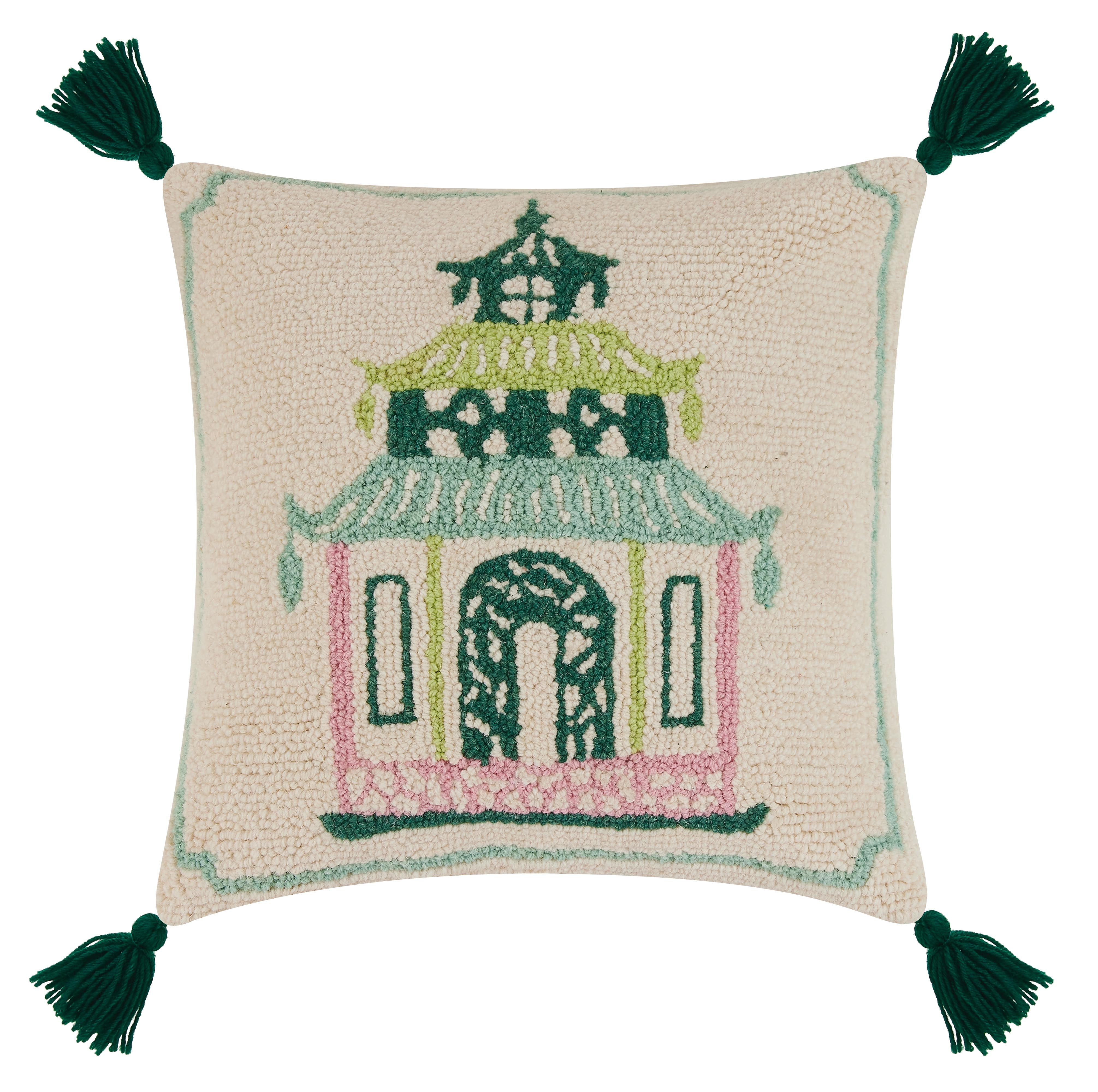 a cream cushion with a central pink and green pagoda motif