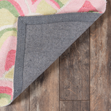 reverse side of a pink and green rug