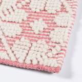 Seville wool pink and ivory patterned flatweave area rug with subtle woven motif and textured design.