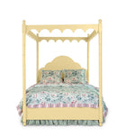 a four poster yellow canopy bed with floral bedding 