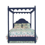 a four poster navy blue canopy bed with floral bedding