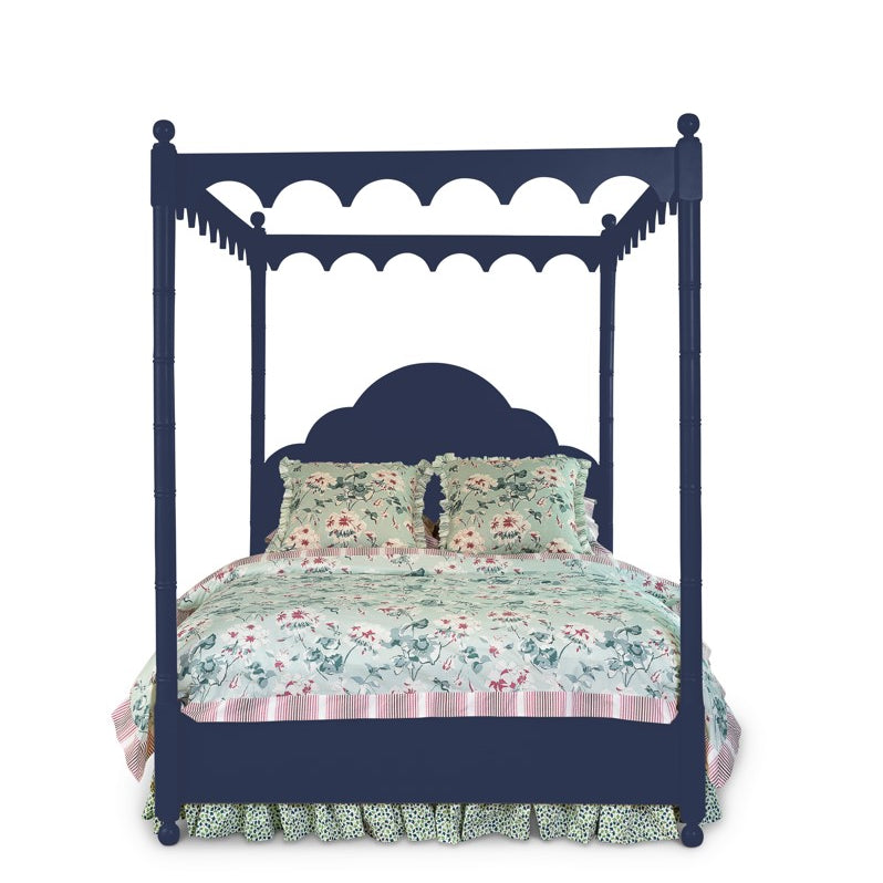 a four poster navy blue canopy bed with floral bedding