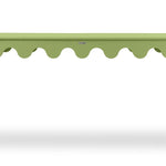 A green console table with scalloped edges