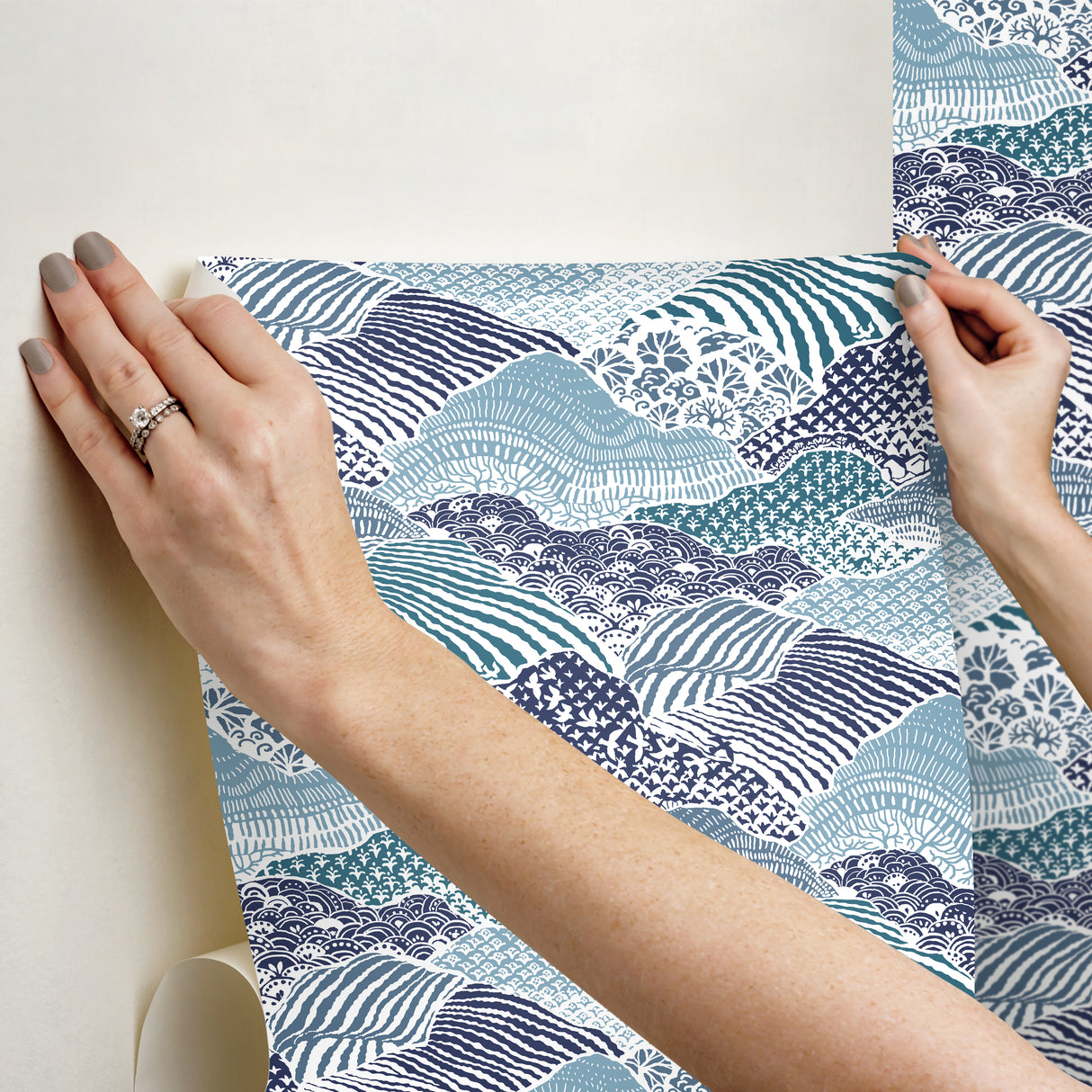 two hands hanging block print motif blue removable wallpaper