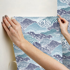 two hands hanging block print motif blue removable wallpaper