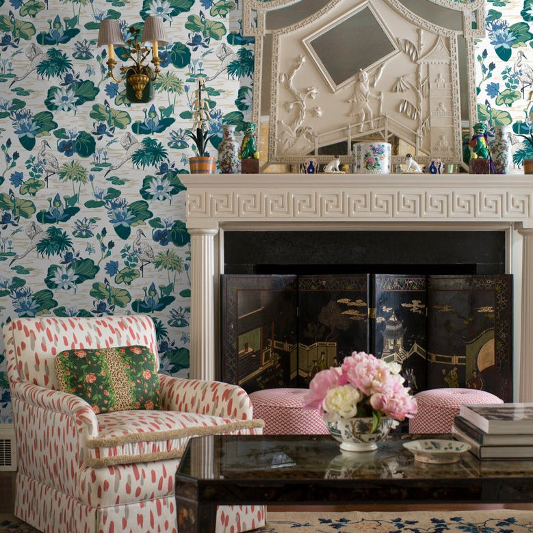 lounge room featuring a wall of green and blue wallpaper and a fireplace.