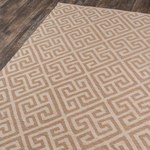 A beige and brown geometric pattern area rug.