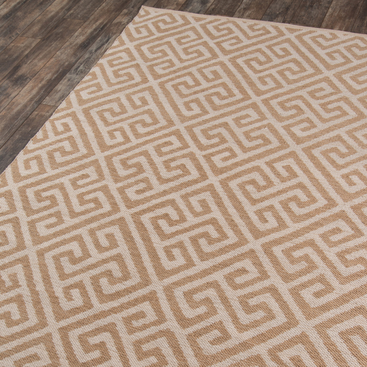 A beige and brown geometric pattern area rug.