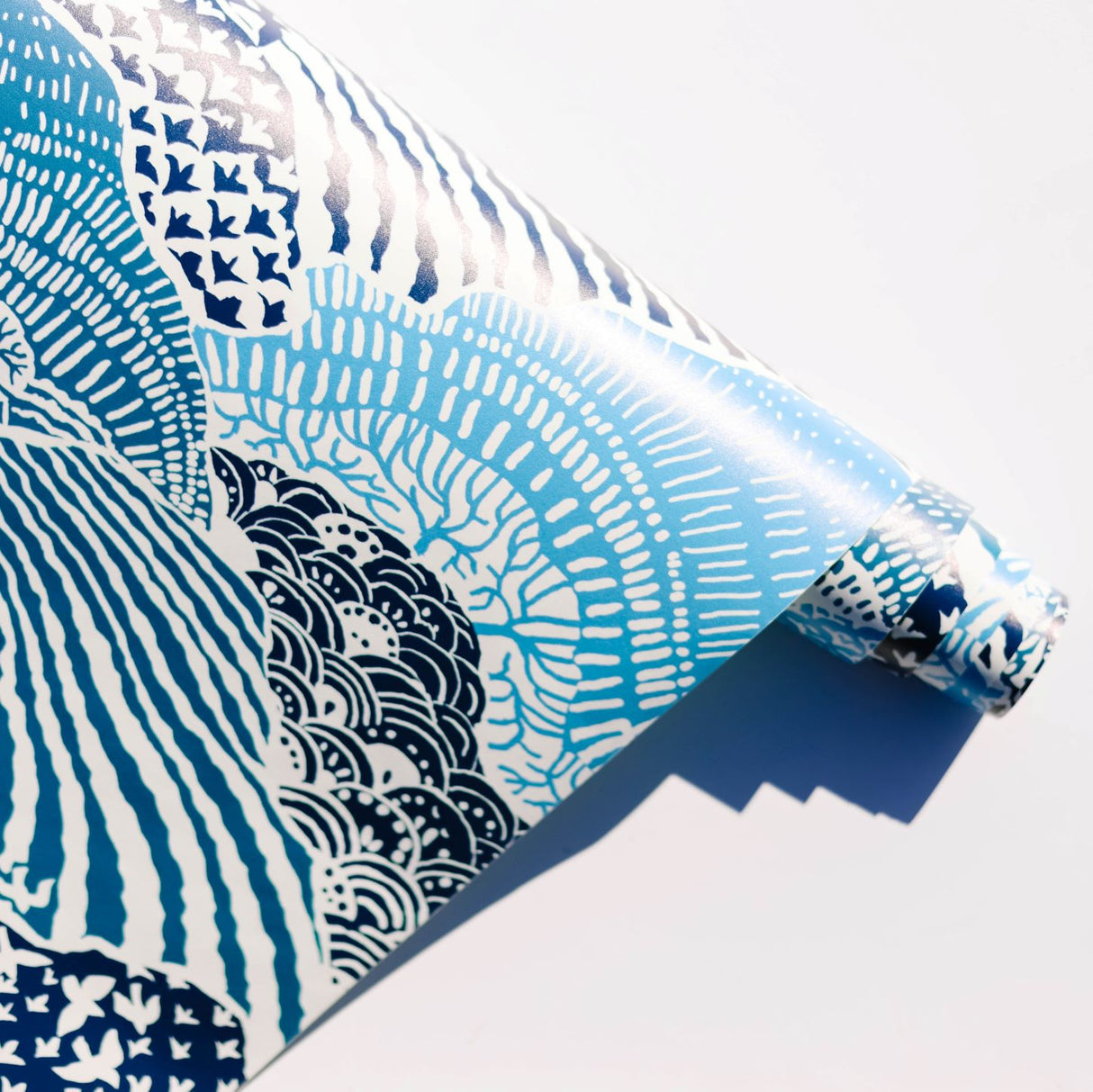close up of a block print inspired blue peel and stick wallpaper 