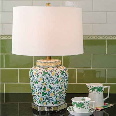 a porcelain strawberry lamp with strawberry, lemon and leaf motifs and a plain white shade