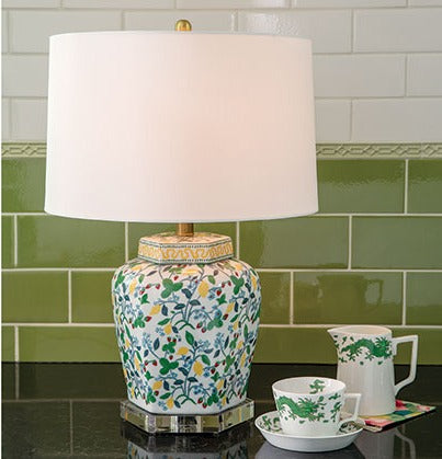 a porcelain strawberry lamp with strawberry, lemon and leaf motifs and a plain white shade