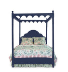 a four poster navy blue canopy bed with floral bedding 