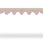 a pink console table with scalloped edges