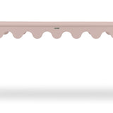 a pink console table with scalloped edges