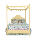 a four poster yellow canopy bed with floral bedding