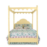 a four poster yellow canopy bed with floral bedding