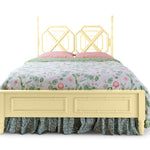 A yellow faux bamboo bed with chinoiserie bedding from madcap cottage
