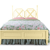 A yellow faux bamboo bed with chinoiserie bedding from madcap cottage
